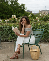 a lady wears striped off shoulder top with loose fit white pants